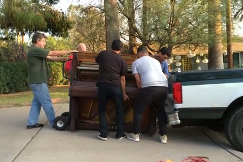 Loading an upright piano onto the truck