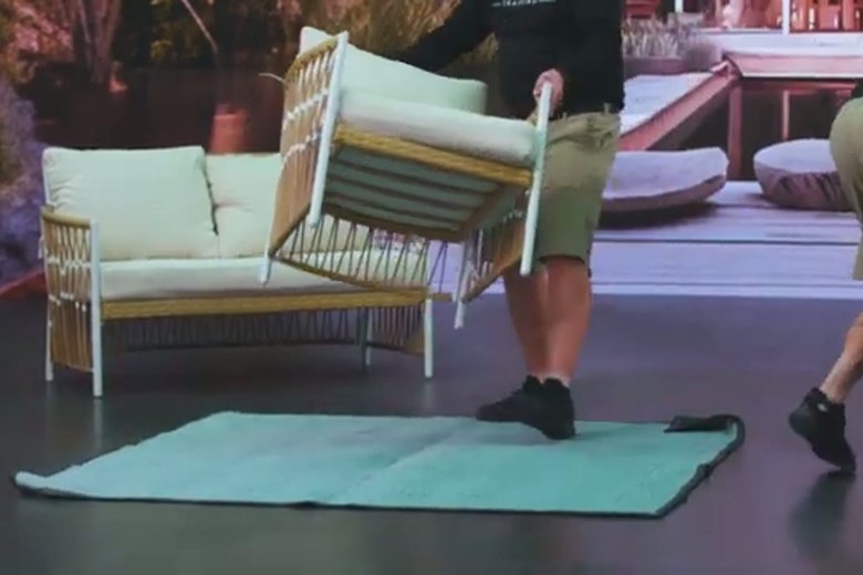 Carrying a wicker sofa out the door